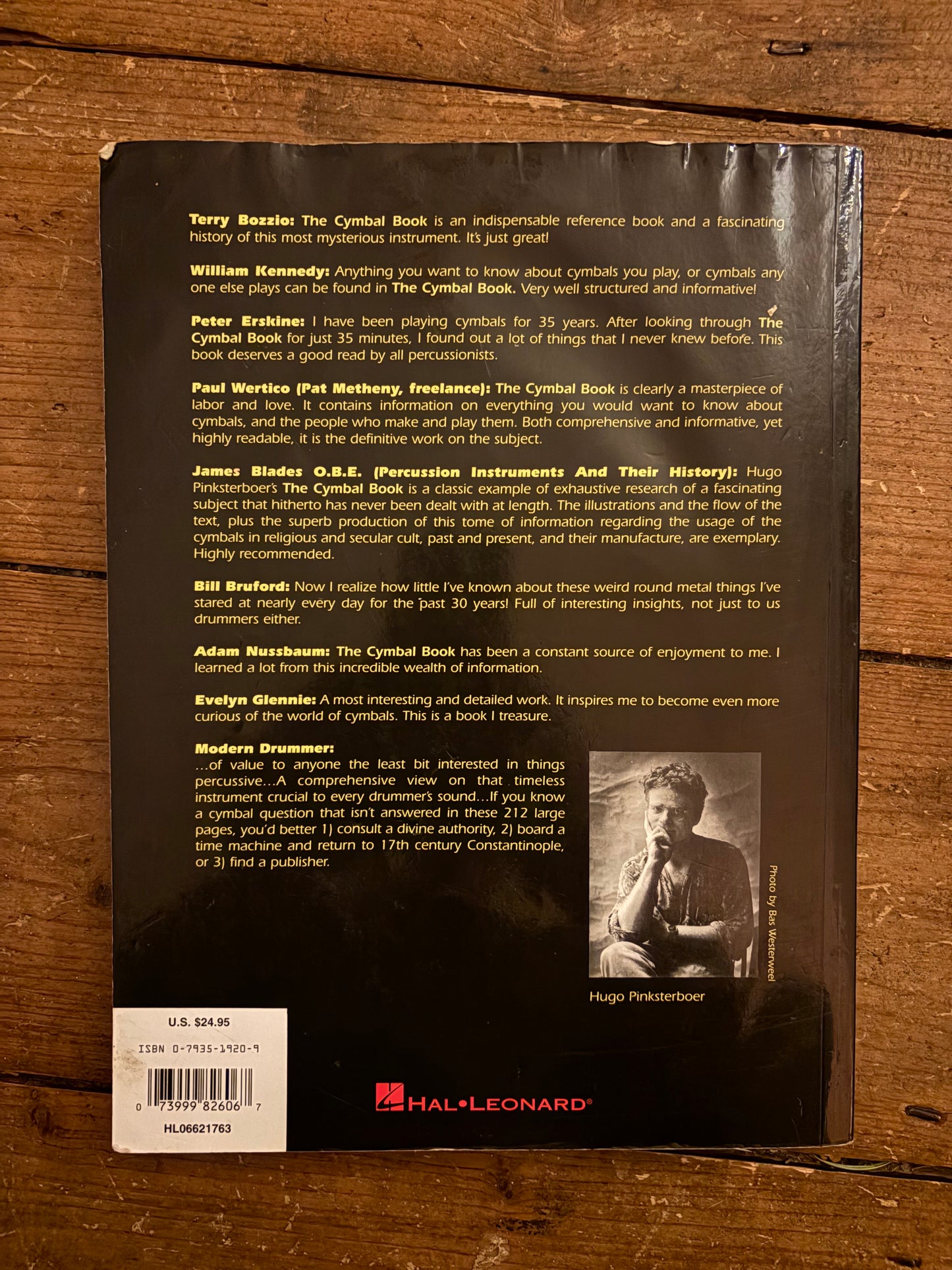 Back cover of a book with text and a photo on a wooden surface