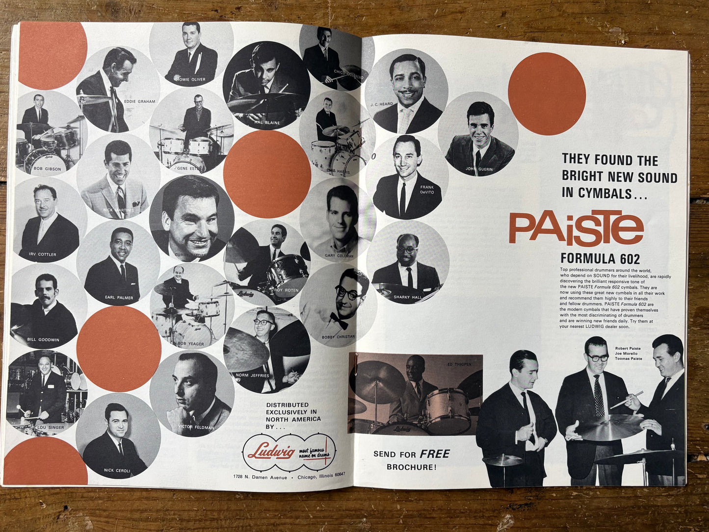 Open magazine or book with Paiste cymbals advertisement on a wooden surface