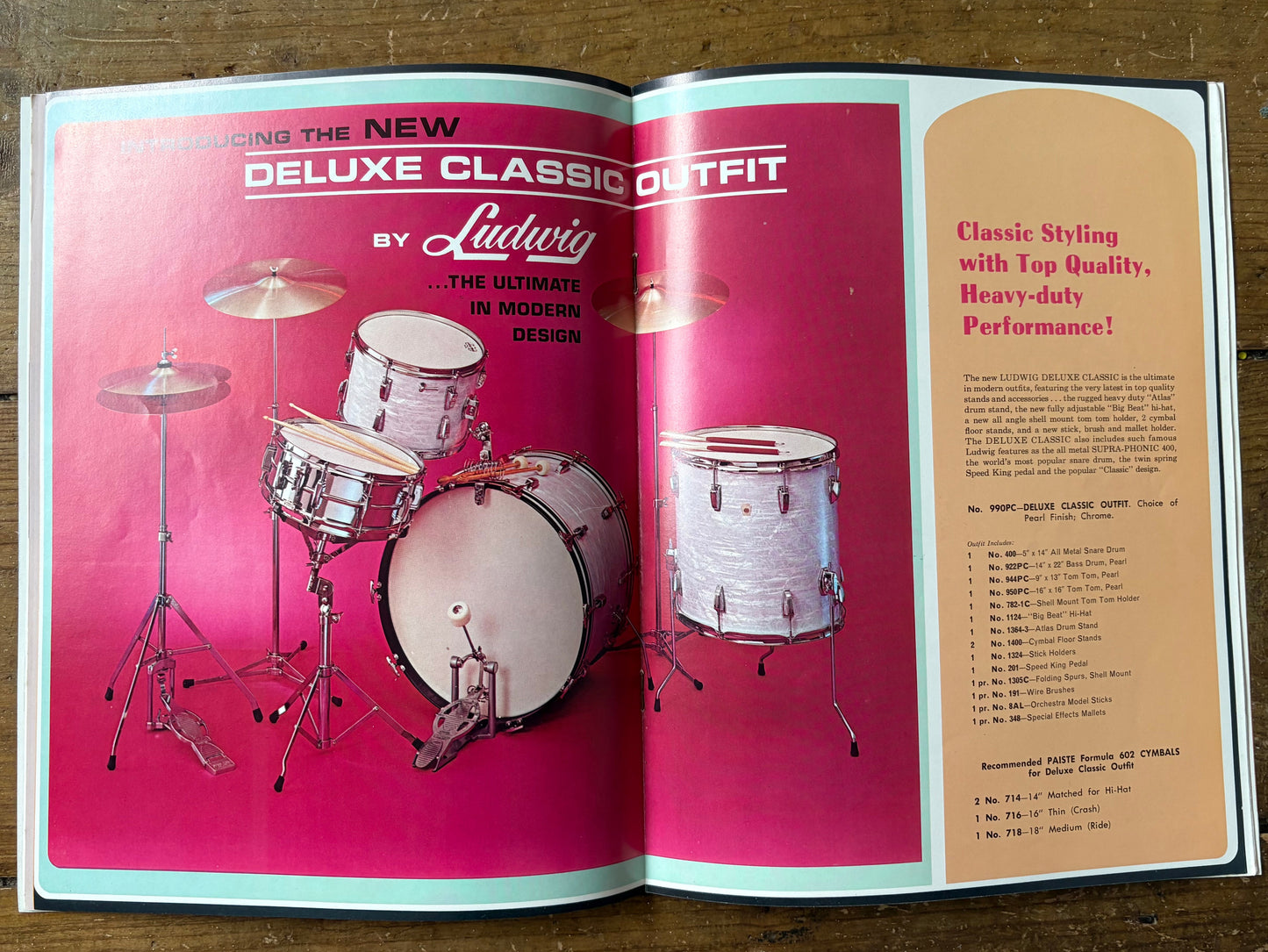 Open book showing a vintage Ludwig drum set advertisement on a wooden surface