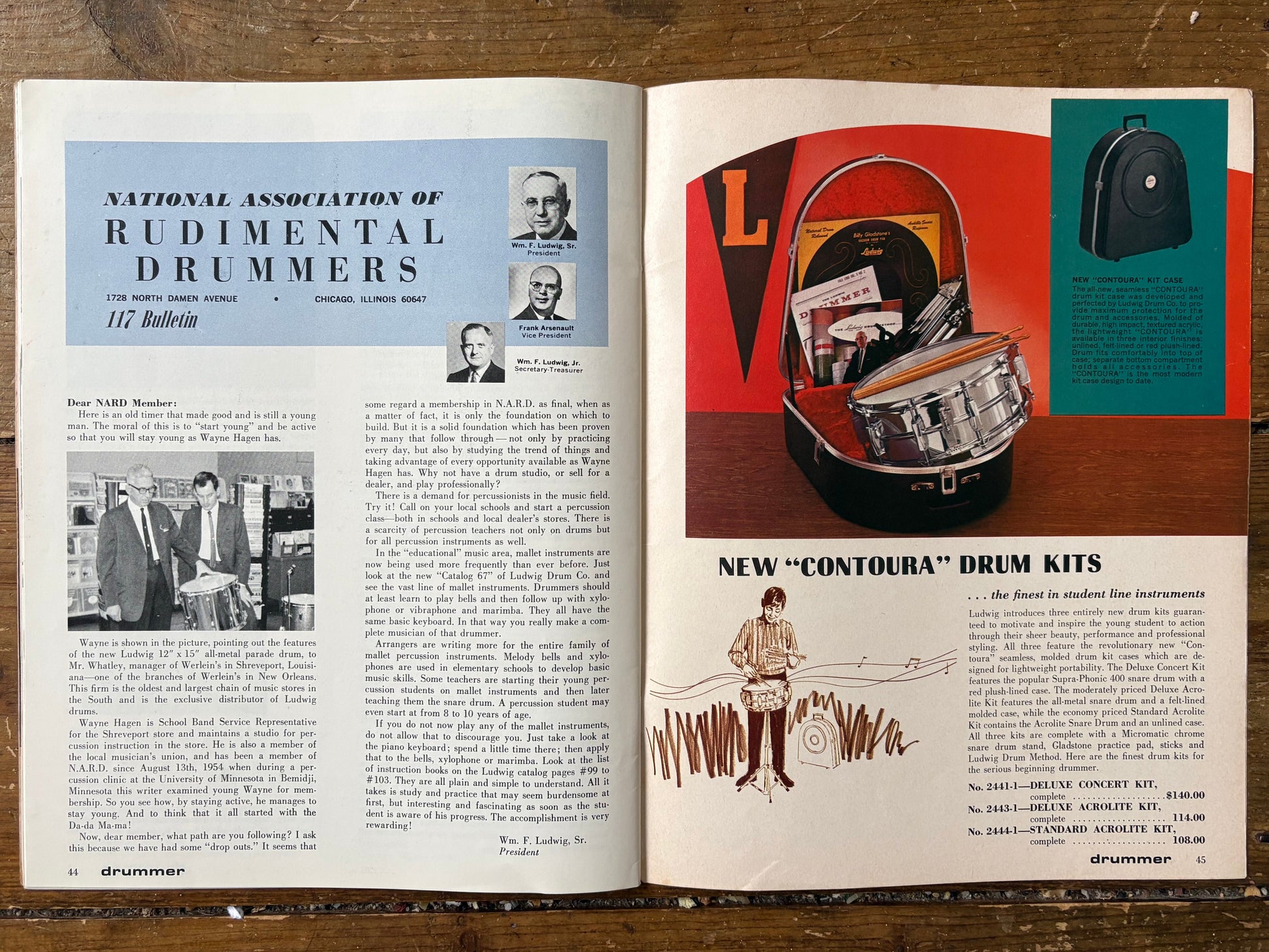 Open book showing a page about the National Association of Rudimental Drummers and an advertisement for Ludwig drum kits on a wooden surface.